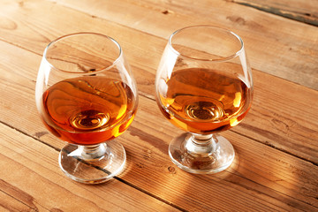 Glasses of cognac on wood