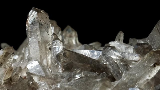 Mountain quartz crystal . Rotates on a black background. Macro
