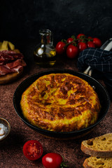 Traditional spanish tortilla omelette on dark rustic table