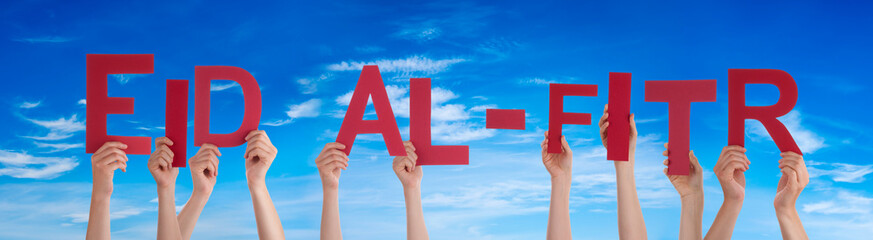 People Hands Holding Red Word Eid Al-Fitr. Blue Sky As Background