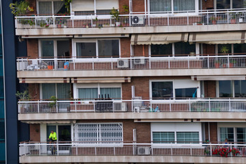 People in balcony during covid-19 confinement. Spain