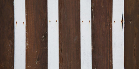 Texture of rustic dark wooden planks aged vertically striped white board background of wood