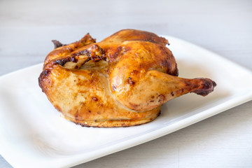 whole roasted chicken isolated on grey background