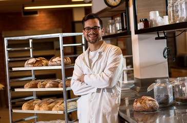 Portrait of young male baker standing at bakery.