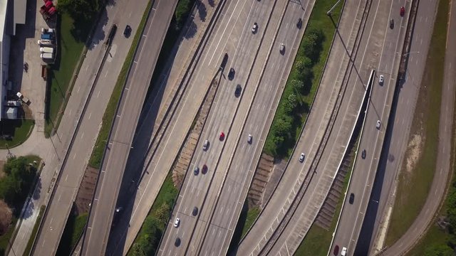 Spinning Top Down Aerial View of the Multiple Lanes Freeway intersection. Rotating Bird's Eye view of the Traffic of The Interstate Highway I45 Interchange In Houston Texas.