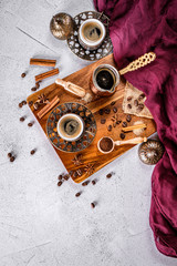 White coffee table with coffee beans, ground powder and spices. Arabic traditional styled coffee