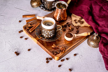 Detail of a turkish coffee cup, coffee beans and ground powder on a white background with space for text