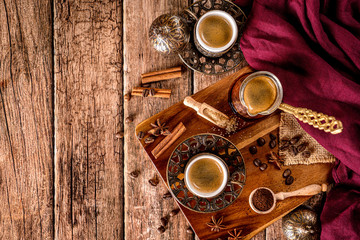 Coffee cup, beans and spices top down view with space for text