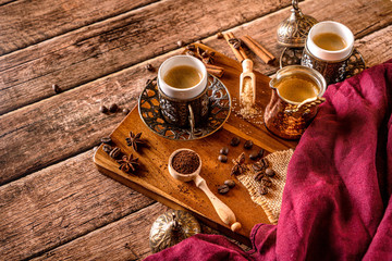 Traditional turkish coffee, coffee-pot  coffee beans on a natural dar aged wood background