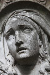 Virgin Mary ancient stone statue as symbol of faith, love and hope.