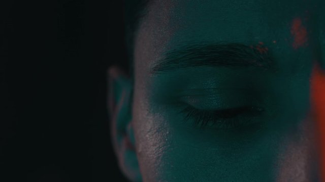 Man looks around in a dark room