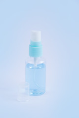 Fototapeta na wymiar Antiseptic bottle for disinfection hands on blue background. Antibacterial antiseptic for coronavirus COVID-19