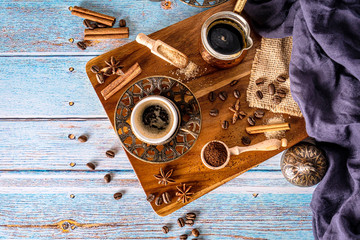 Coffee cups with coffee beans and pot. Vintage coffee arrangement on old wood background