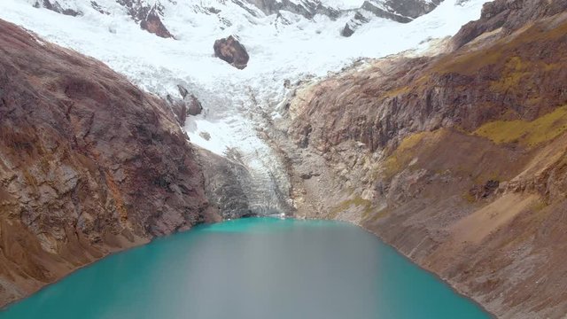 Arhuaycocha lake, in the sante cruz trekk, peruvian andes, reversal fly, aerial shot.