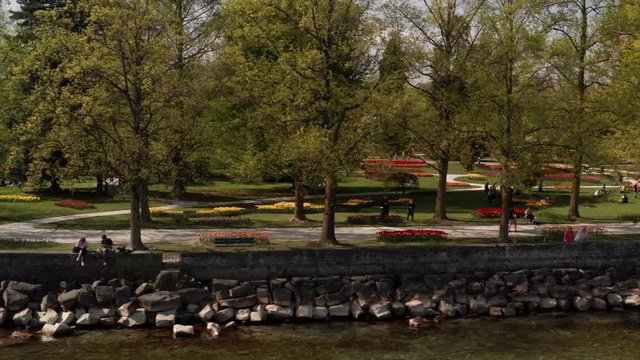 Aerial dolly of visitors in Parc de l'Ind&eacute;pendance during Tulip Festival