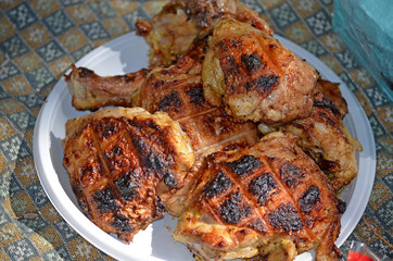 Grilled parts of chicken on the grill. Cooking meat on coals