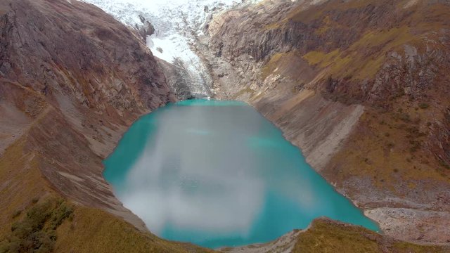 Arhuaycocha lake, in the santa cruz trekk peruvian andes, panoramic view, aerial reversal shot.