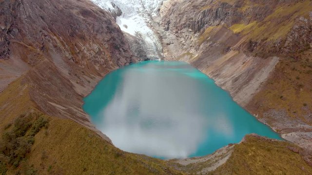 Arhuaycocha lake in santa cruz trekk, frontal fly, aerial shot, panoramic inmersive view.