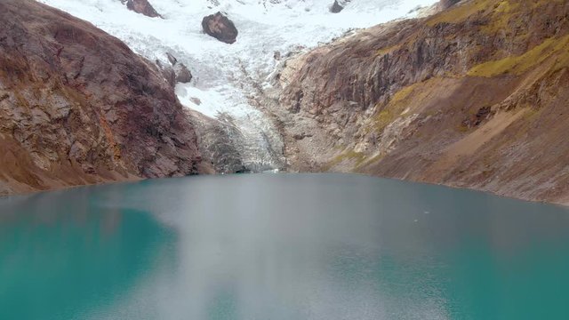 Fly over the Arhuaycocha lake, in the santa cruz trekk, Frontal and smooth shot in the peruvian andes.