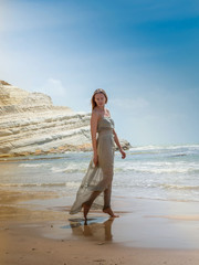 young woman walking on the beach fly dress