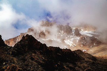 Mount Kilimanjaro. View from Arrow Glacier Camp to summit. Volcano Kibo. Rocks and clouds