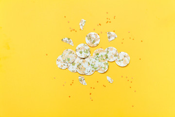 Vegeterian bean chips and lentils on yellow background. Top view.