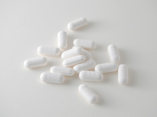 white medical tablets over white