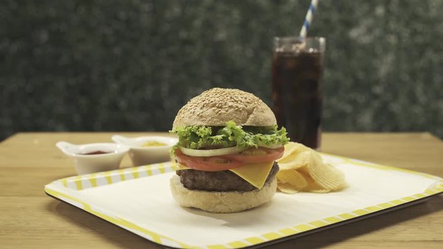 Cheeseburger with chips and soda plus ketchup and mustard 4k