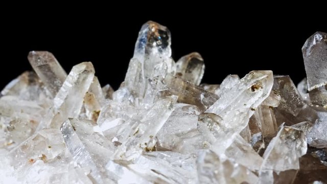 Mountain quartz crystal . Rotates on a black background. Macro