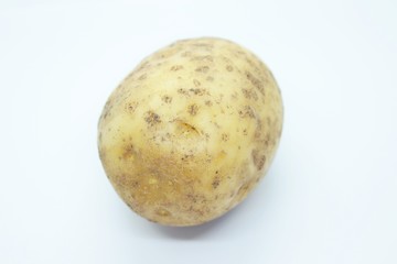 Raw ripe potatoes are located on a white background