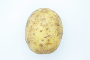 Raw ripe potatoes are located on a white background