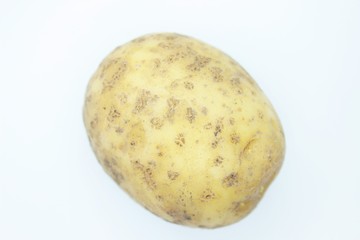 Raw ripe potatoes are located on a white background