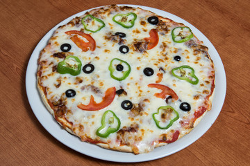 Homemade pizza with olives and cheese.