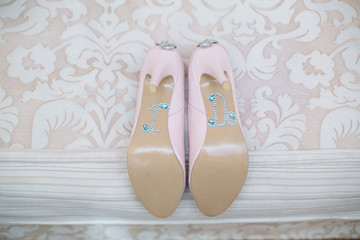  pink bridal high heels shoes decorated with shiny rhinestones and stones close up. women's shoes decorated the inscription 