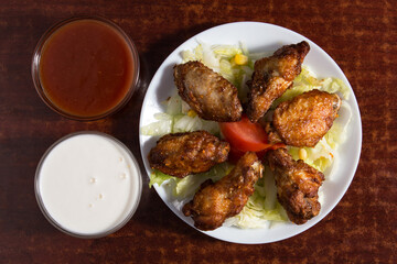 Chicken wings in sauce.