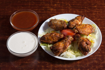 Chicken wings in sauce.
