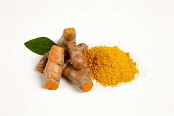 Bunch of ripe dried organic turmeric roots laid in composition on white background. Curcuma at table counter. Clean healthy eating concept. Background, close up, flat lay, top view.