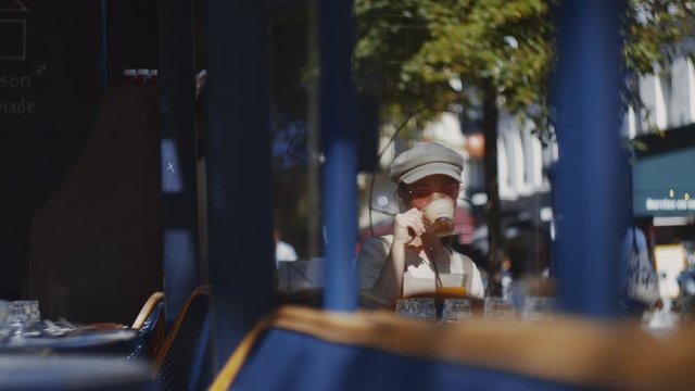 Young tourist having breakfast in a cafe in Paris