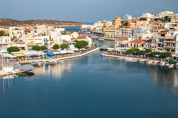 Fototapeta na wymiar top view of a quiet bay and the Greek resort town of Agios Nikolaos on a sunny summer day