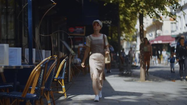 Young girl walking in a cafe, Paris