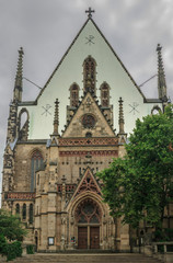 Facade of the Church of St. Thomas. Cloudy day. Leipzig. Germany. Soft focus, blurry background.