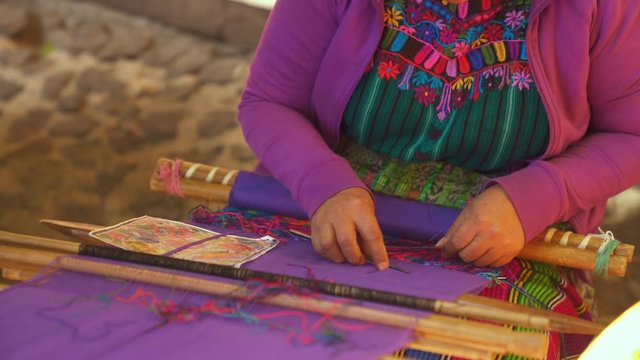 Guatemalan woman weaving blanket on a loom Close Up