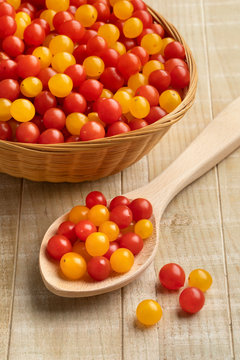 Basket with red and yellow Tomberry tomatoes close up