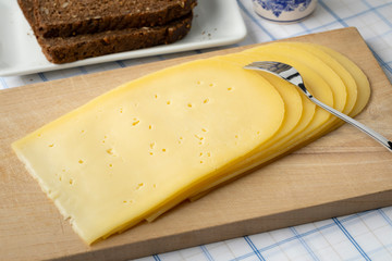 Slices of young Gouda cheese close up