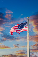 American Flag blowing in the wind at the top of a flagpole
