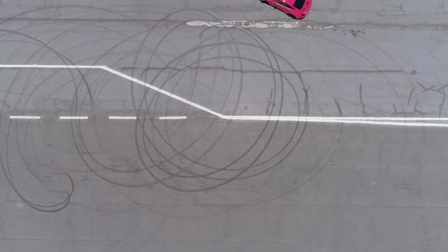 Aerial view of a racing car going in circles on a race track.