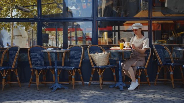 Young girl in a street cafe in Paris