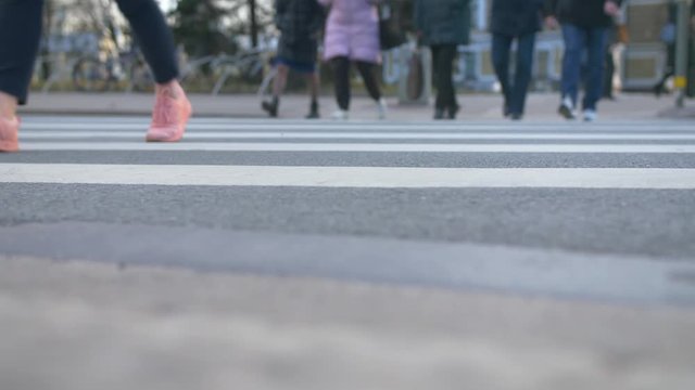 Pedestrians crossing crosswalk after work
