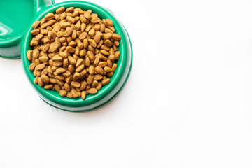 dry pet food in bowl on white background top view. bowl full and overflowing with dry pet - dog food bits on white background top view mock-up