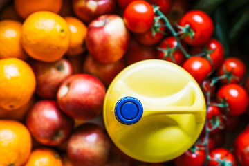 Fruit and vegetable box with a bottle of lye. Disinfecting fruits and vegetables with a bottle of bleach.